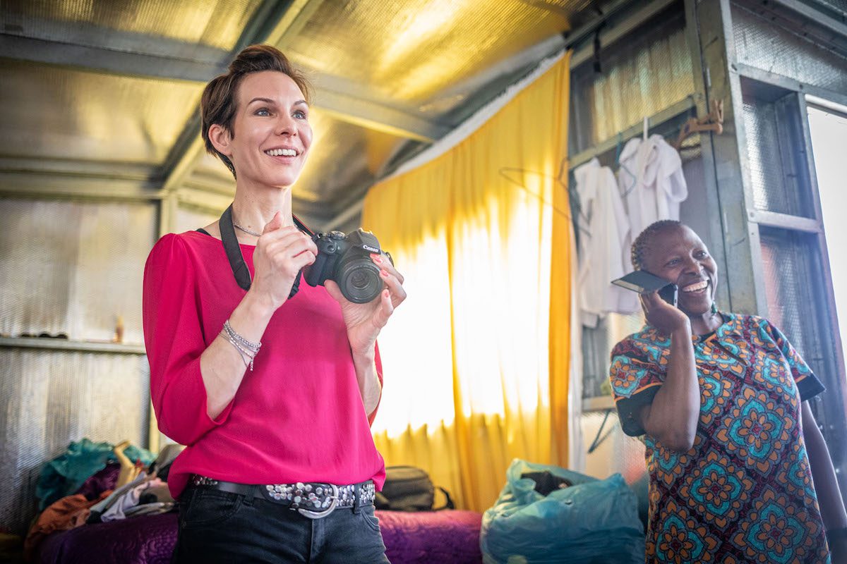 International volunteer capturing photos in a local community, highlighting cultural engagement and fieldwork experience.