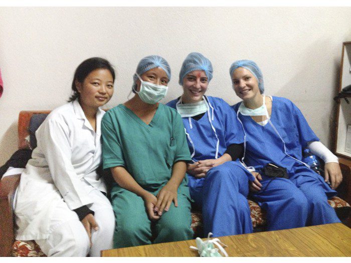 Global health interns and local healthcare staff wearing scrubs, demonstrating hands-on medical internship opportunities abroad