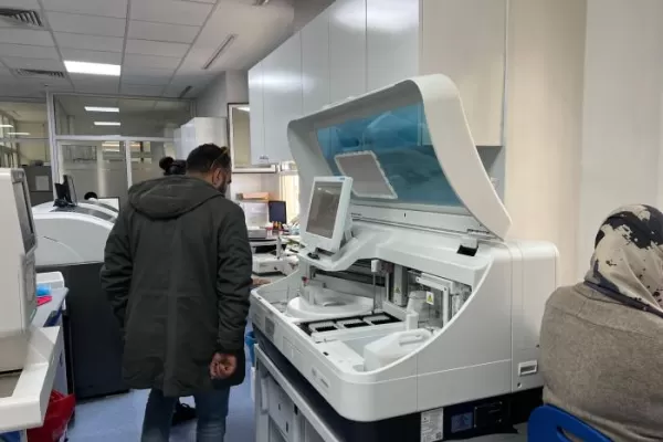 Medical interns observing advanced lab equipment, emphasizing the practical skills gained through international clinical programs.